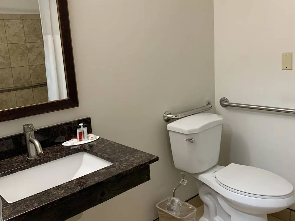 Accessible bathroom with grab bars and an open vanity